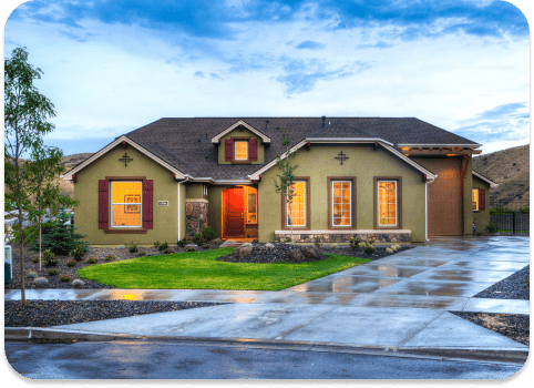 A single-storey home lit at dusk after an exterior repaint